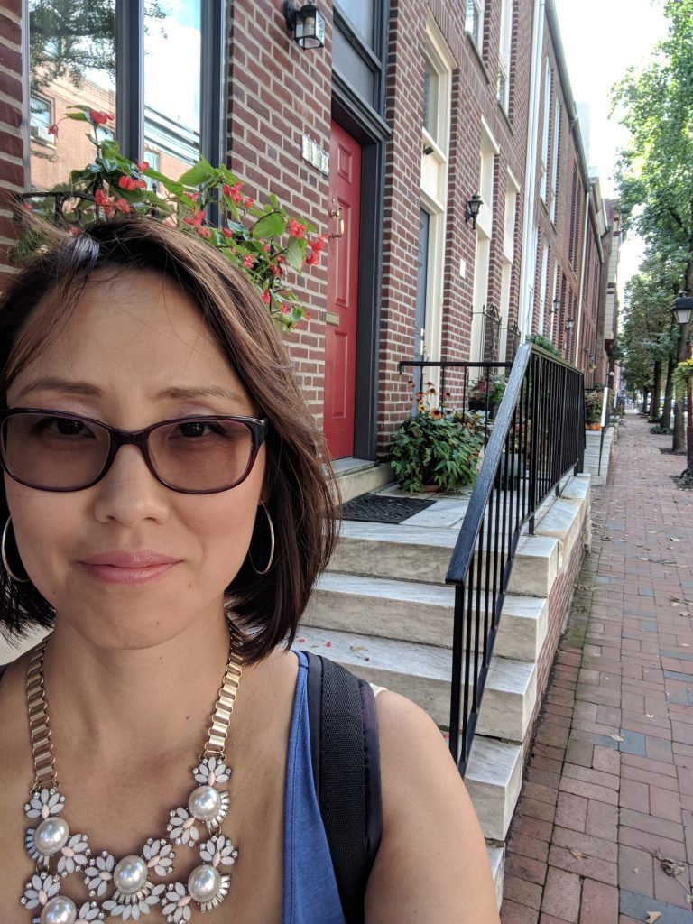 a woman with short hair clicking a selfie