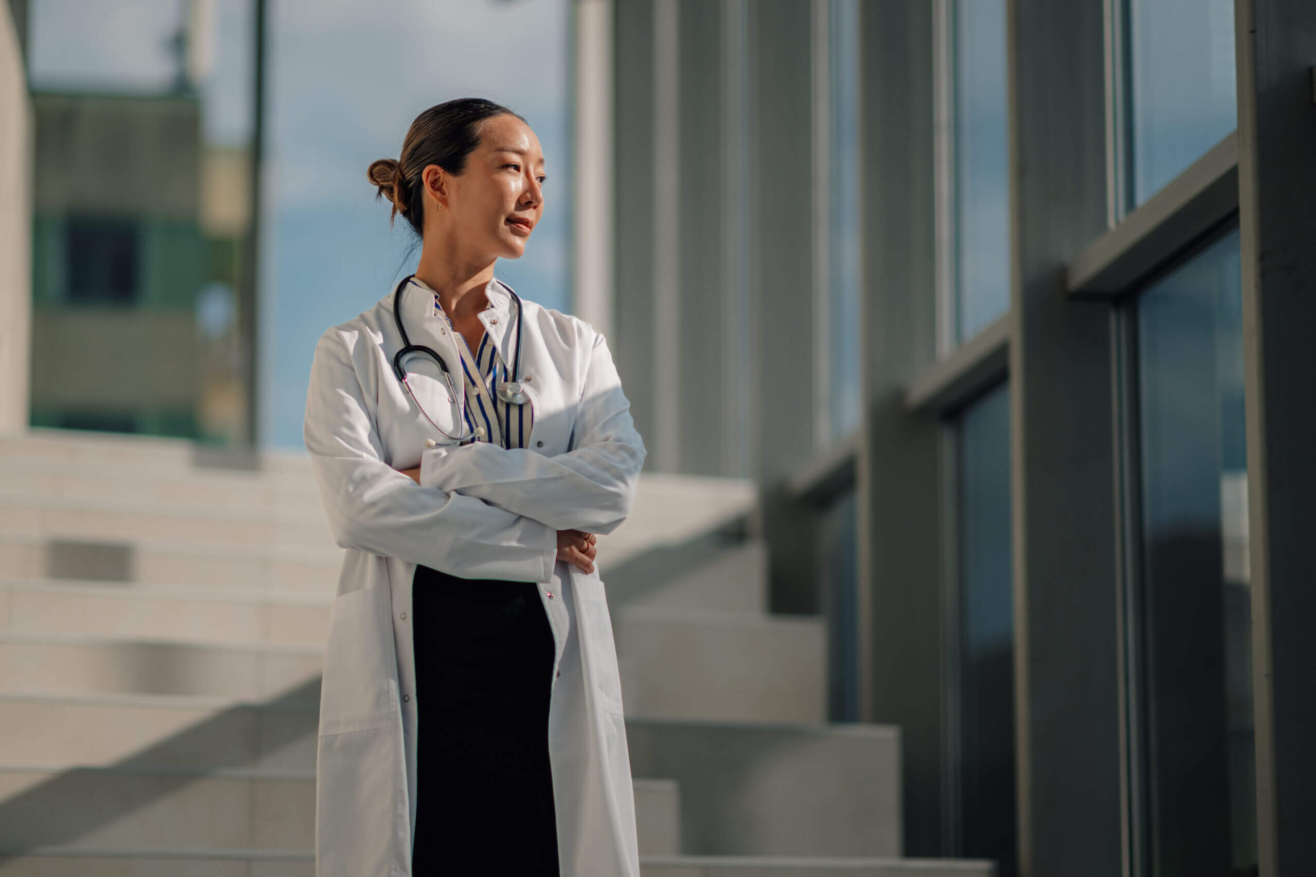 Doctor standing on stairs, wearing lab coat. Doctor standing on stairs, wearing lab coat.