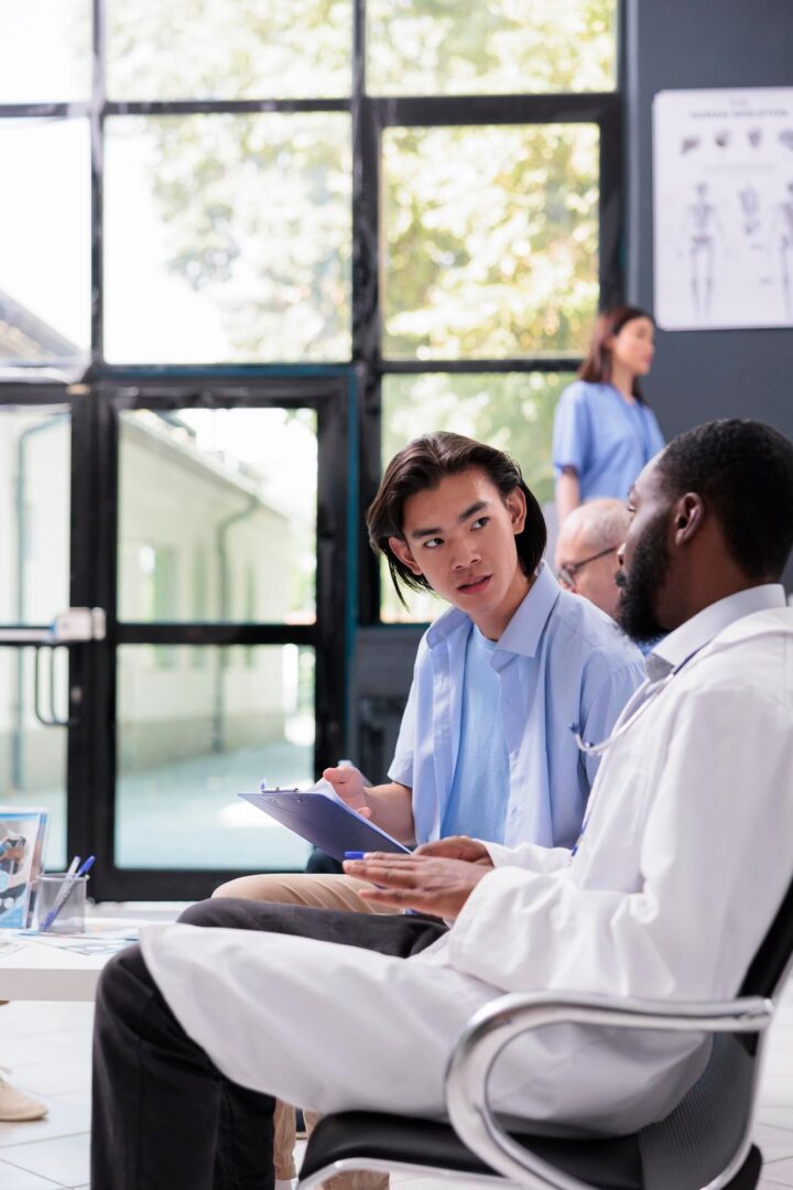 Doctors discussing in a hospital waiting area. Doctors discussing in a hospital waiting area.
