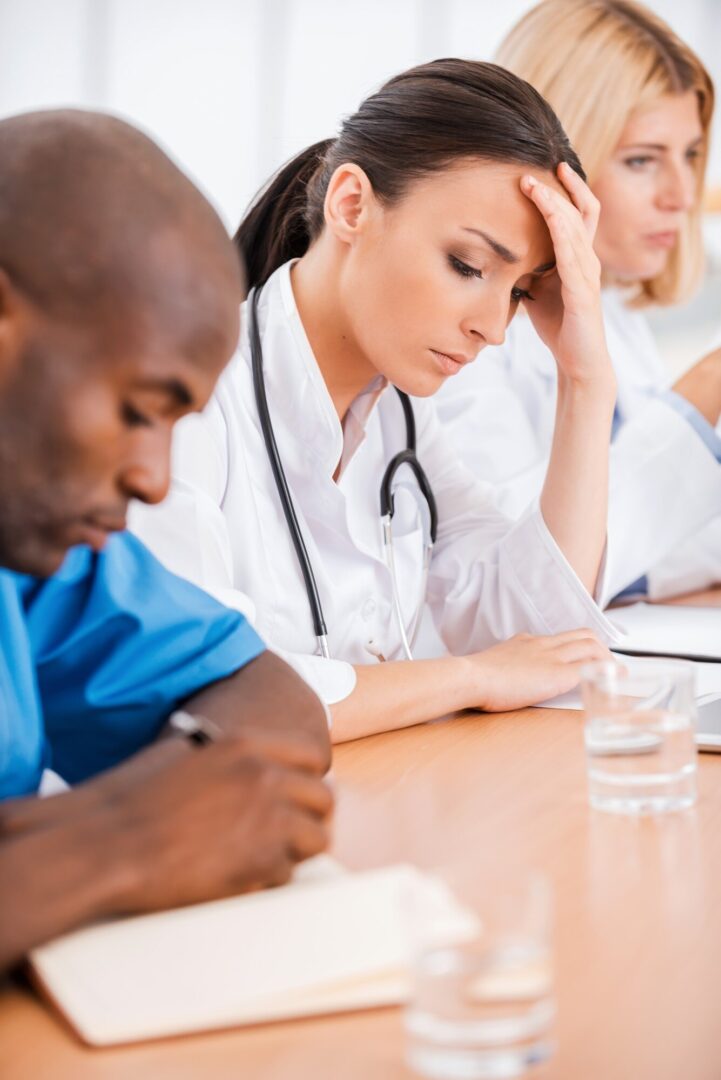 Healthcare professionals in a thoughtful meeting.