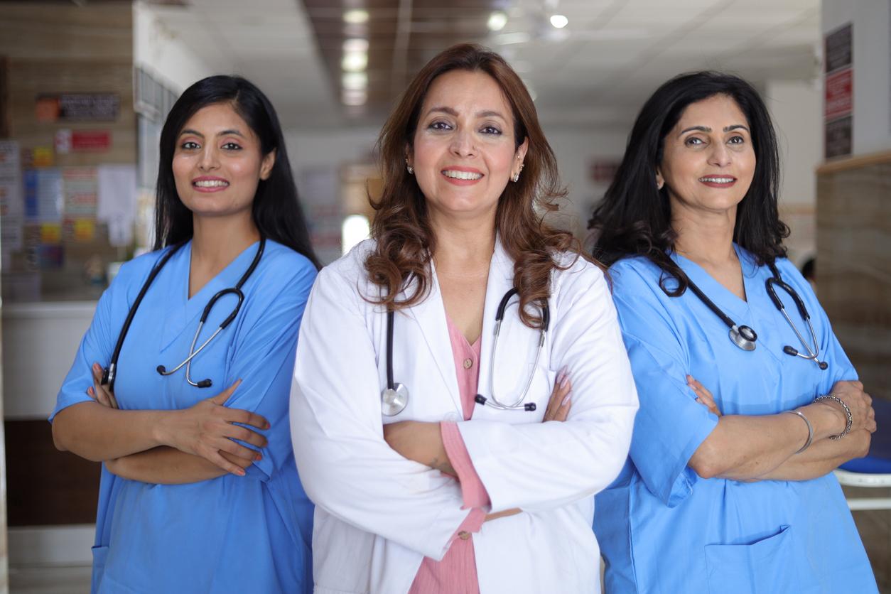 Three smiling healthcare professionals with stethoscopes